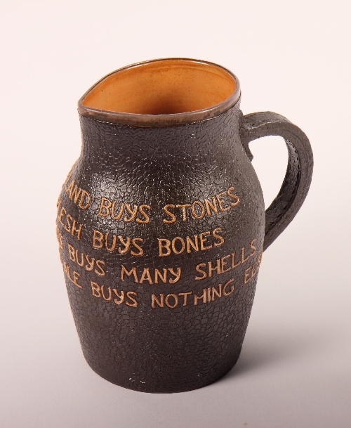 A Doulton jug in the form of a leather jack decorated verse, 8 1/2" high