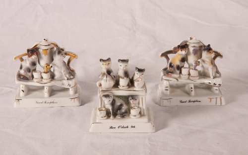 Three continental porcelain fairings of cats, two "Good Templars" and "5 o`clock Tea"