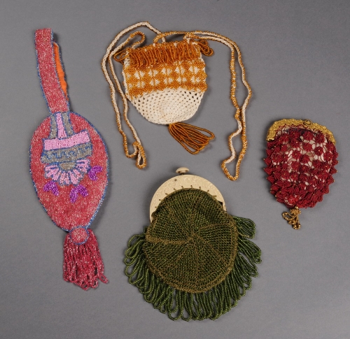 A 1930s knitted frame purse worked with green beads, a crochet purse knitted with amber coloured