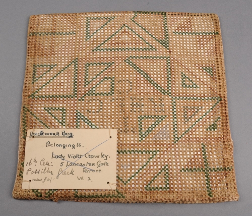 A very fine drawn thread and hand embroidered mesh bag worked in red, green and beige in geometric