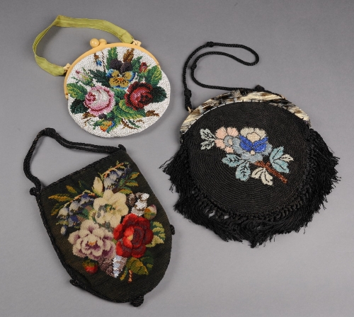 A 19th Century bag with beadwork and raised woolwork roses, a 1920s spiral corded and beaded bag