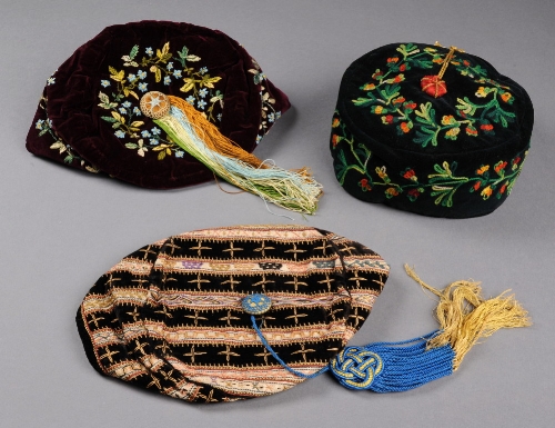 Two Victorian velvet smoking caps, both embroidered with flowers and having a central tassel, and