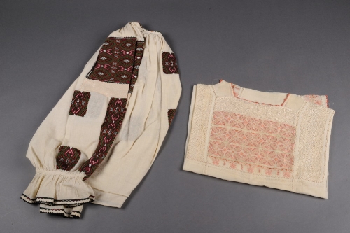 An Eastern European crepe blouse embroidered with a geometric design in a fine gobelin stitch and