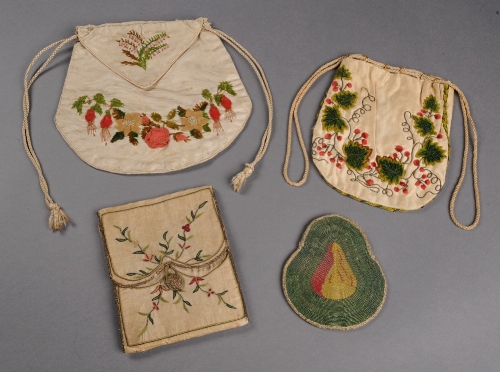 A Regency cream silk needlecase decorated with chain stitch leaf and floral branches edged with gold