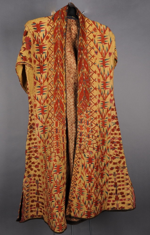 A late 19th Century Turkmen lady`s yellow silk coat embroidered in coloured silks and a later