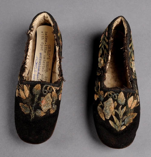 A pair of child`s 19th Century shoes with floral embroidery