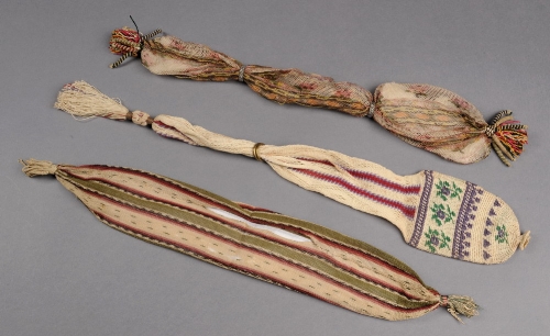 Two Regency printed silk net stocking bags, both with corded tassels (one missing rings) and another