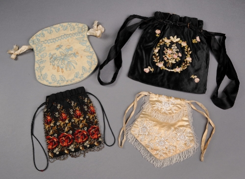A 19th Century black drawstring bag embroidered with fine silk ribbon roses, a 19th Century black