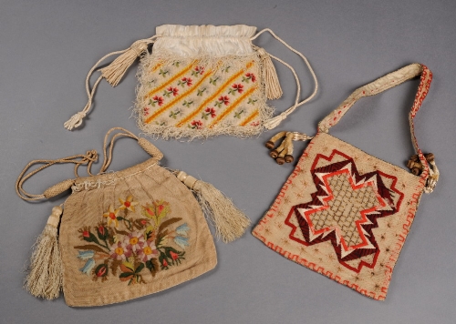 An early 19th Century silk and canvas bag worked with woolwork and silk flowers and edged with