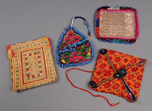 A Baluch purse with appliqué tape motif and red and yellow stitching, a purse embroidered with