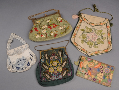 A 1930s woolwork frame bag embroidered with cherries and blossom on a green ground, a 1940s frame