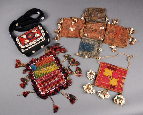 A Banjara multiple bag decorated with cowrie shells, a similar bag with cowrie shell tassels, a