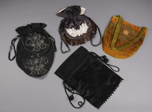 Three circa 1900 black beaded drawstring bags and an Aesthetic Movement green velvet bag with