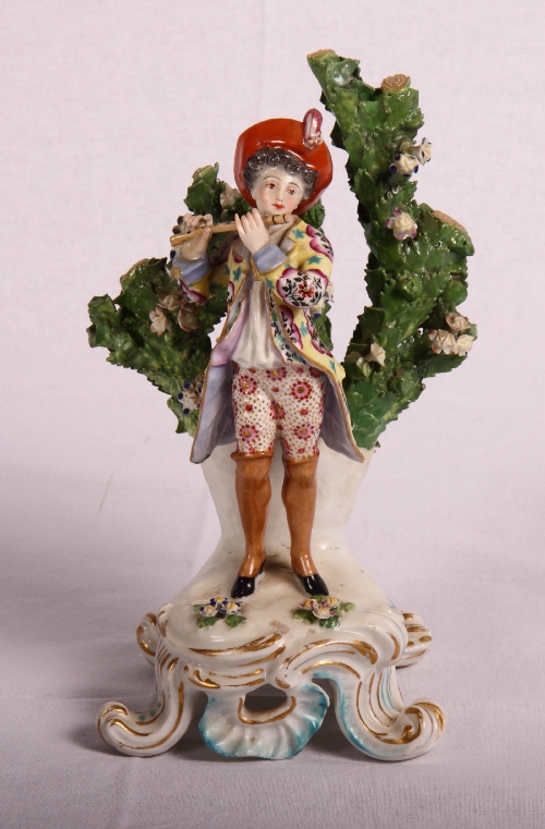 A Derby porcelain figure of a piper on scrollwork base, 8" high