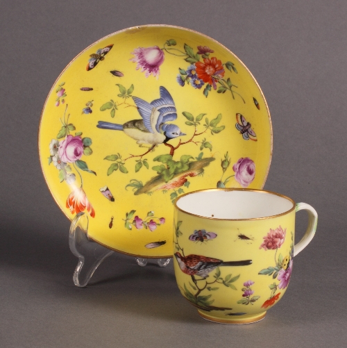 A Meissen yellow ground coffee cup and saucer decorated birds, flowers and insects with branch