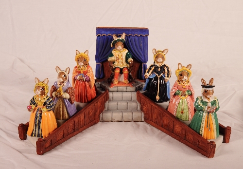 A set of Royal Doulton Bunnykins figures of Henry VIII and his six wives with display stand and