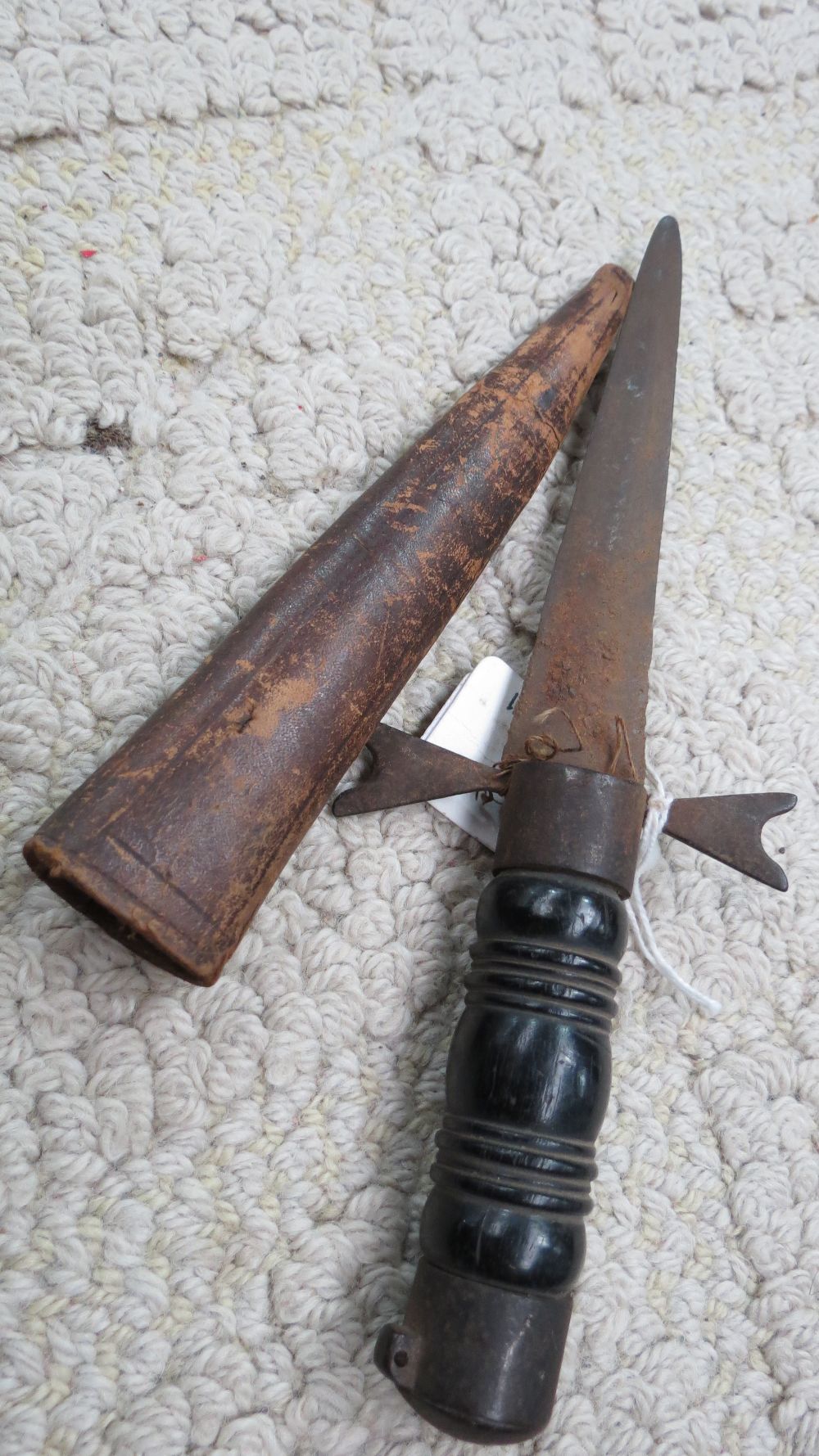 A small dagger with turned wood handle and leather sheath,  blade length 12cm.