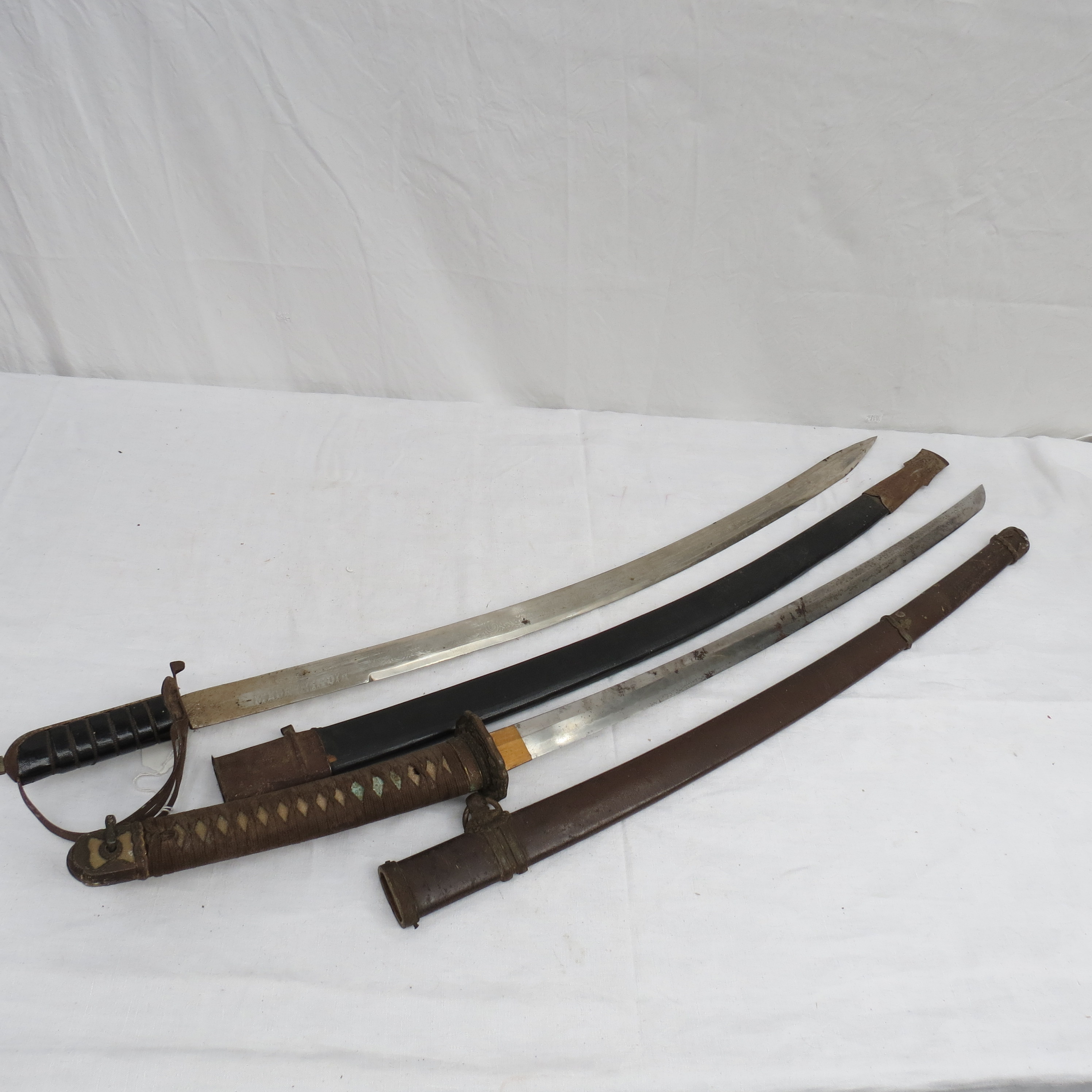 A WW II Japanese sword, with a gilt foliate cast tsuba and bound shark-skin handle and gilt mounts