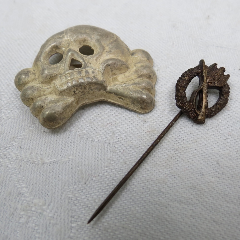 A Nazi Infantry assault stick pin and SS Totenkopf cap badge.