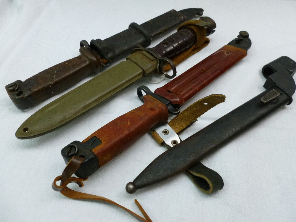 Four assorted bayonets comprising Beretta Mod 70 with canvas frog and green metal scabbard, blade