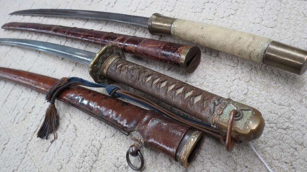 A Japanese shin-gunto, with crisply cast tsuba and mounts, fish-skin handle and leather clad