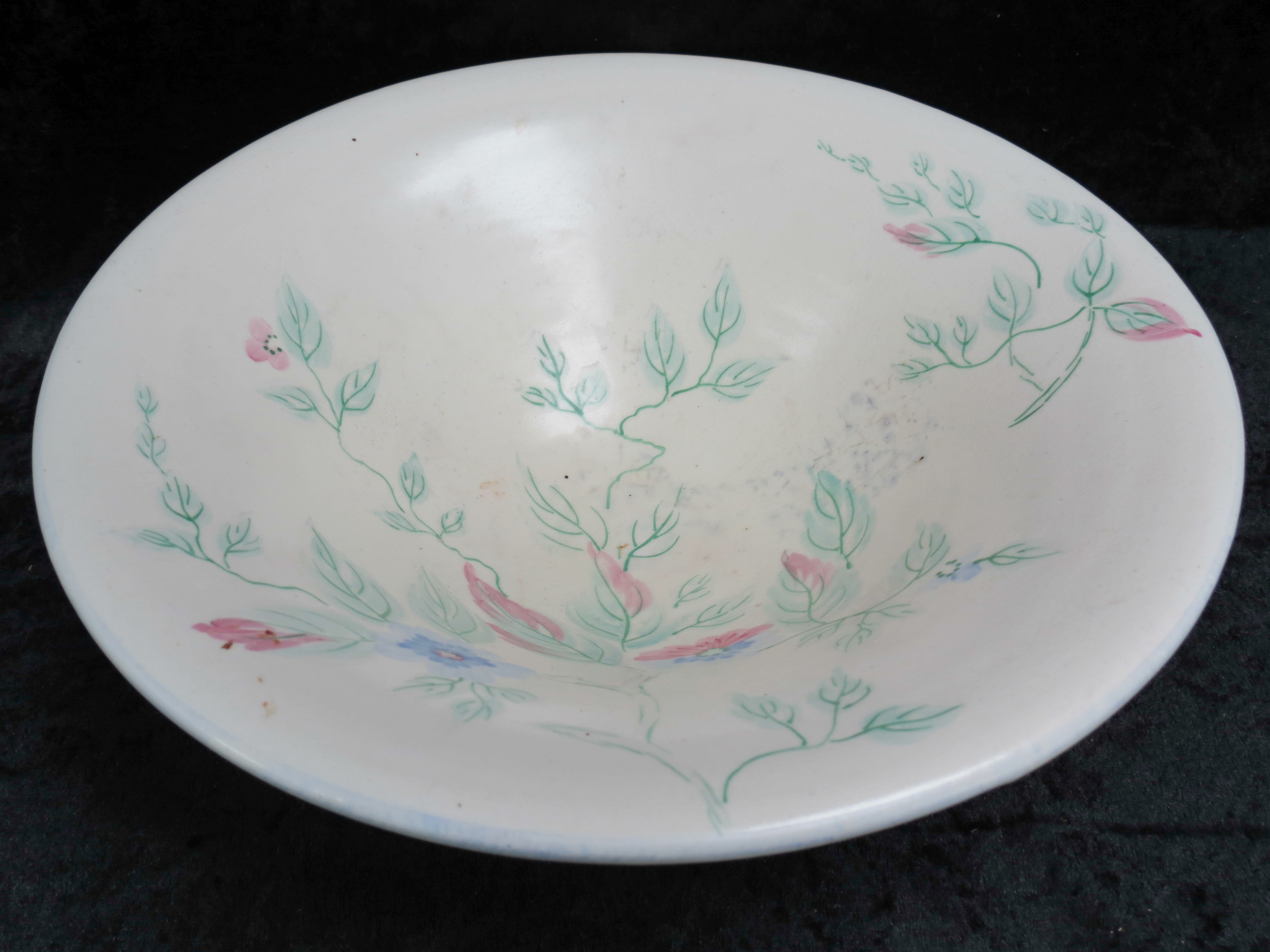 A Bewley Pottery art deco open bowl on three feet, the interior hand painted with flowers, 10.5"