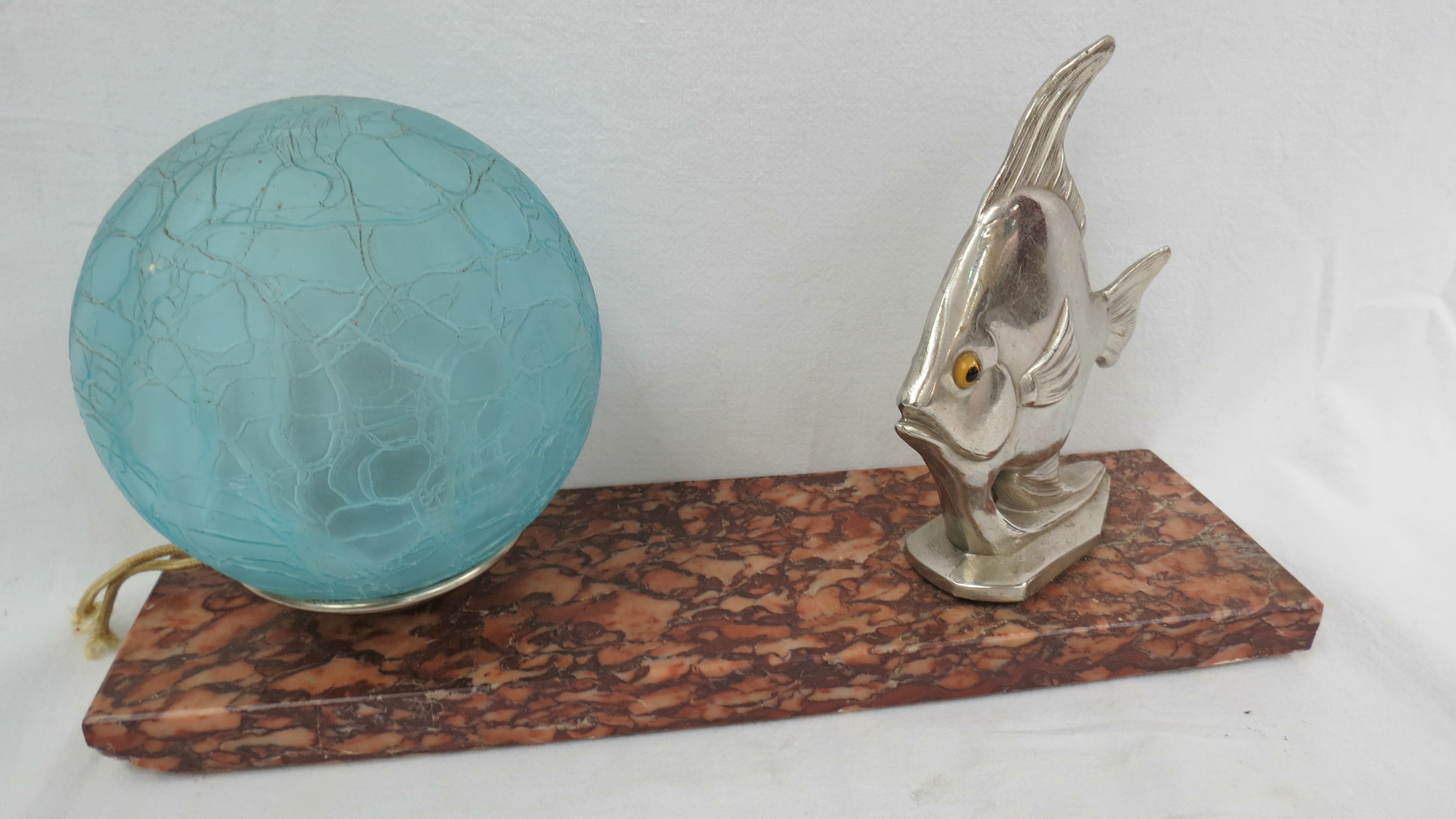 A French art deco lamp mounted with a white metal fish on a marble base. 15cm high.