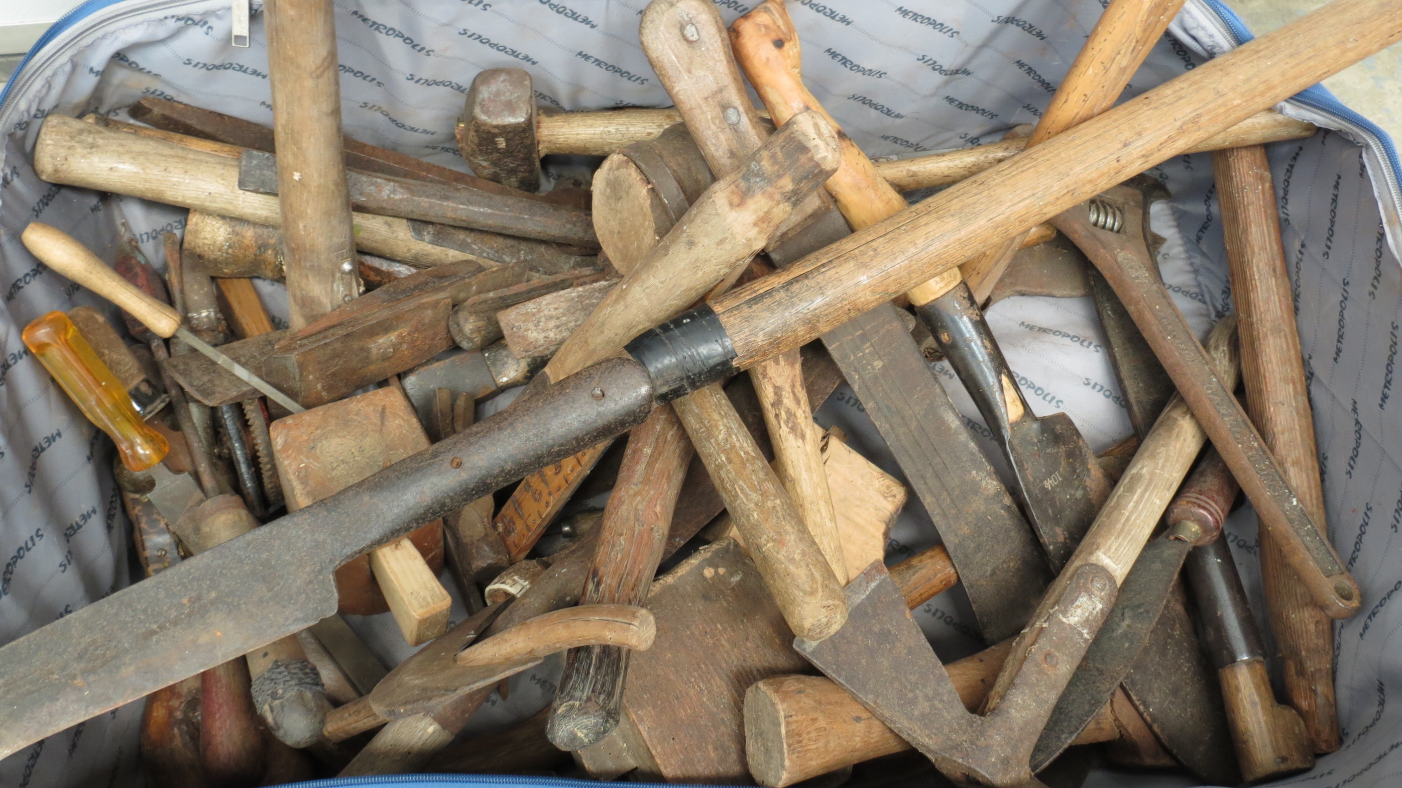 A quantity of tools including hatchets and axes.