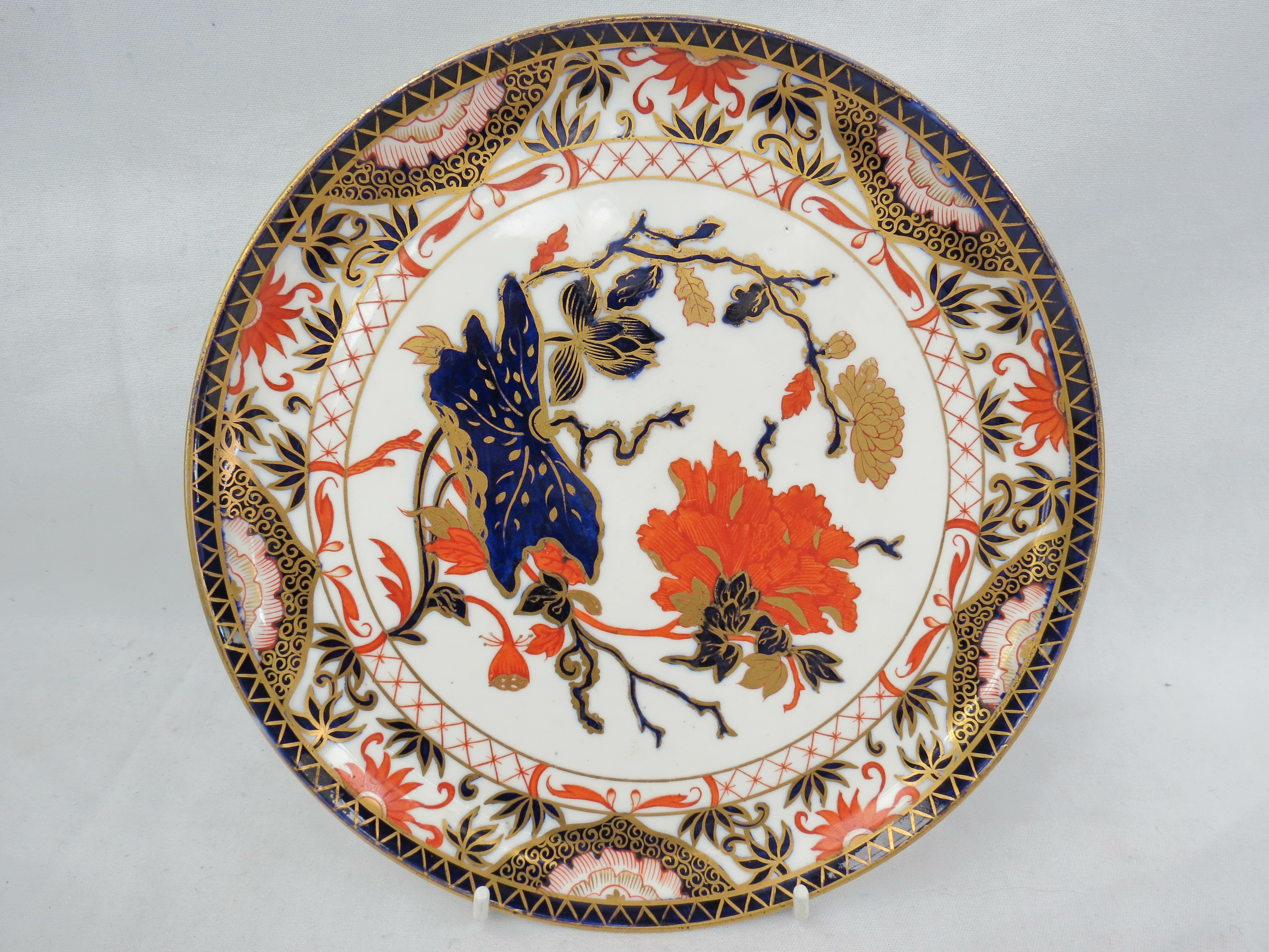 A Royal Crown Derby circular shallow tray with a mark for 1890, decorated in the Imari pallet.