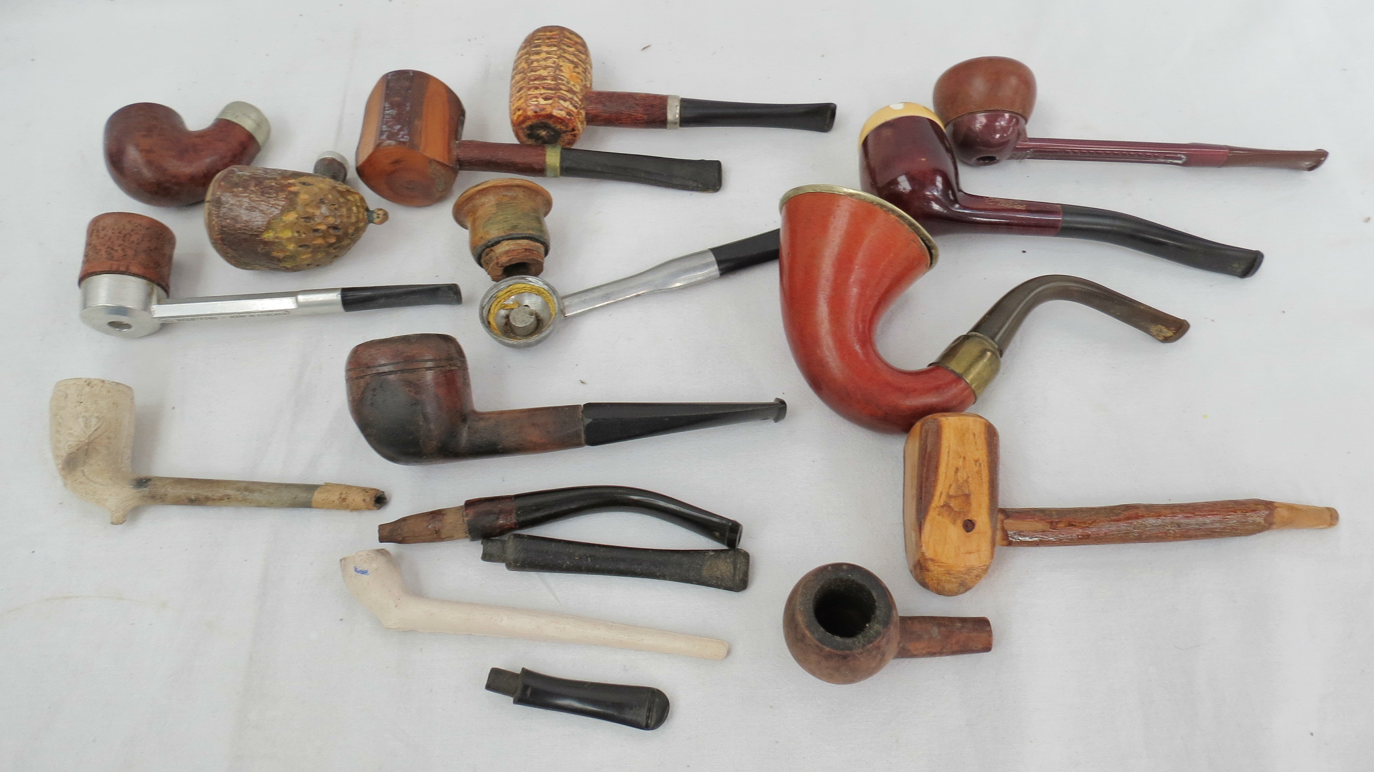 A collection of tobacco pipes of various types including 'Holmen', briars, cobs, clays etc, all in