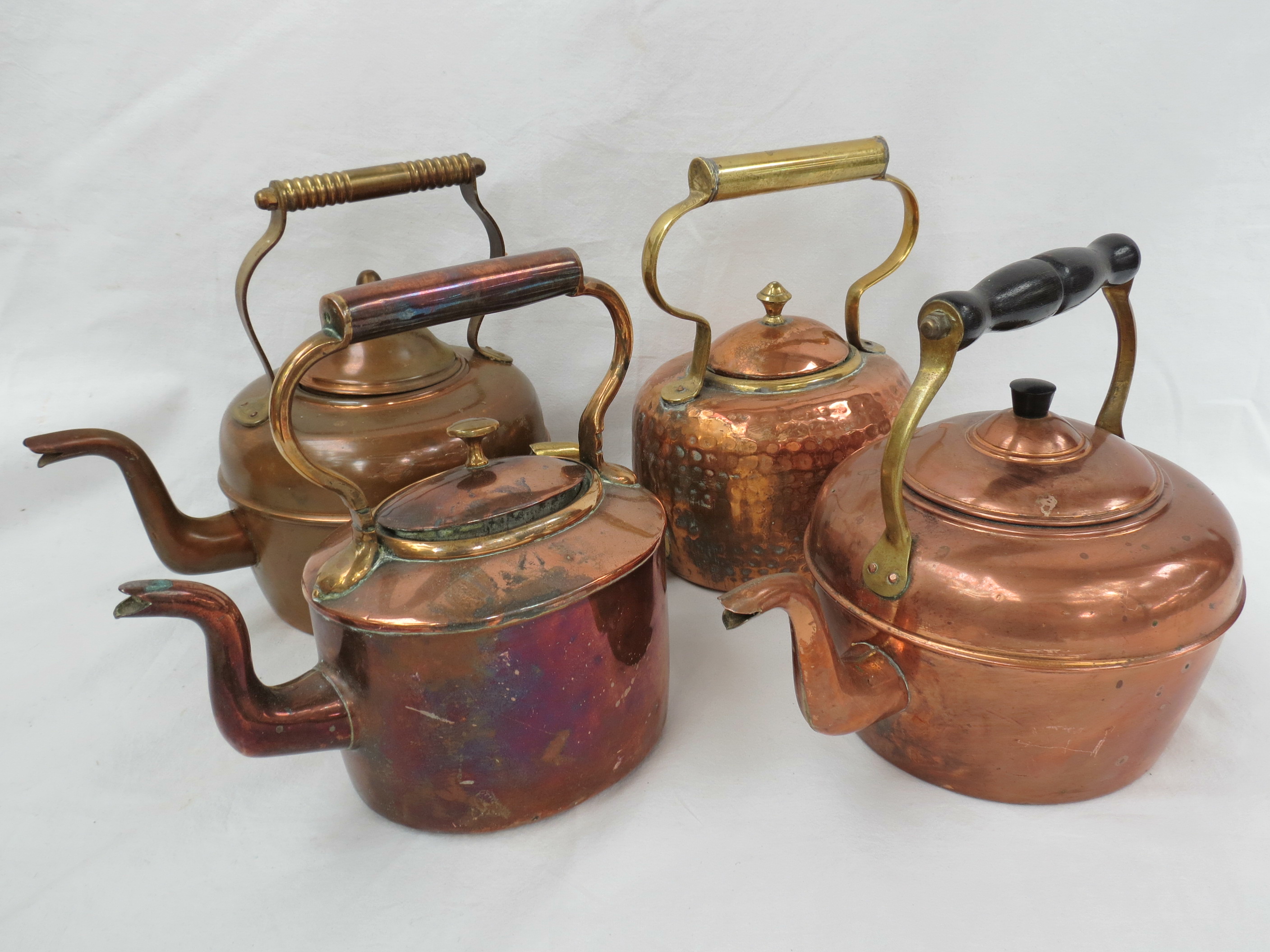Four vintage copper kettles.
