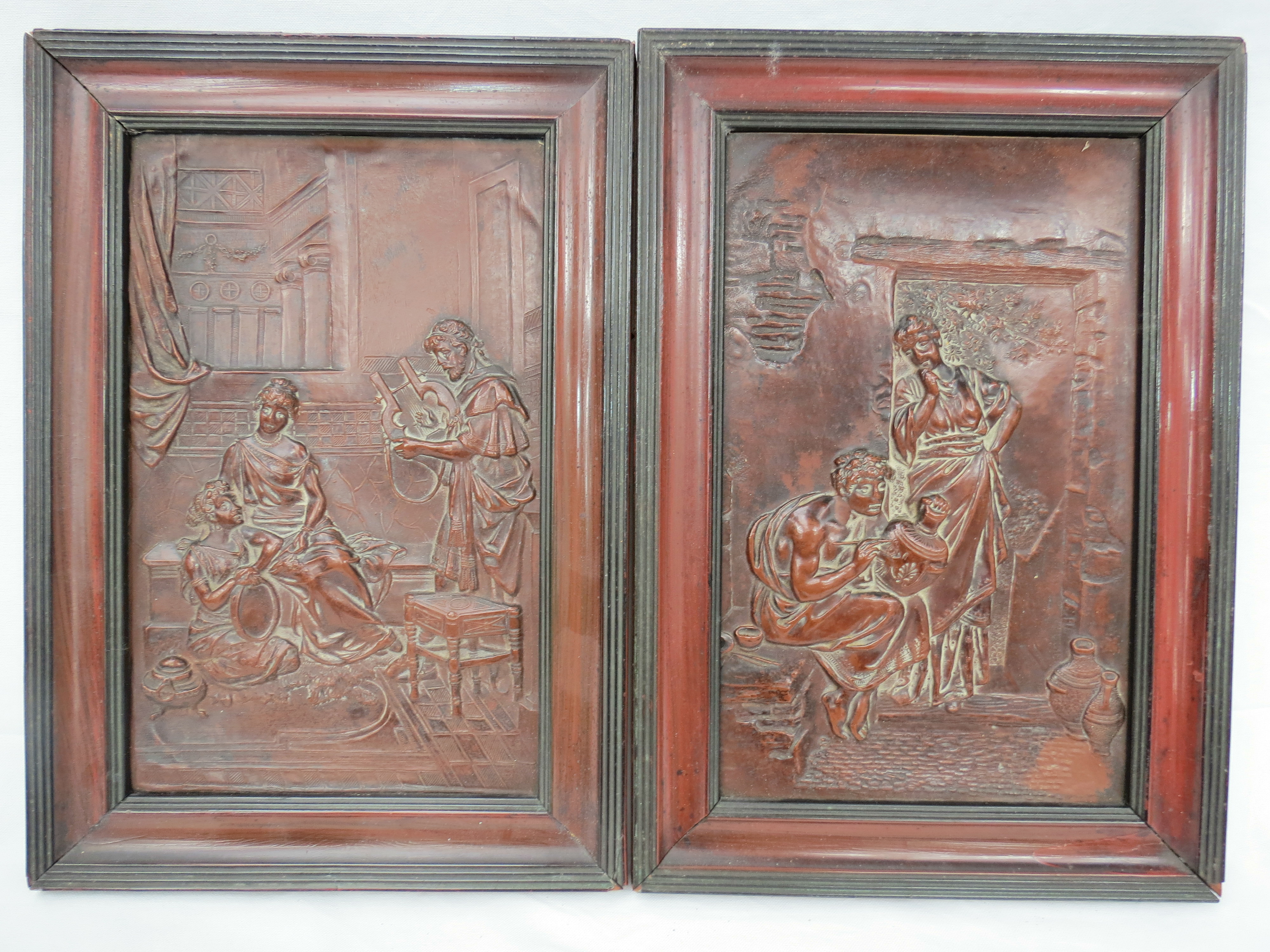 A pair of 19thC embossed and framed copper plaques depicting classical subjects. 24x15.2cm.