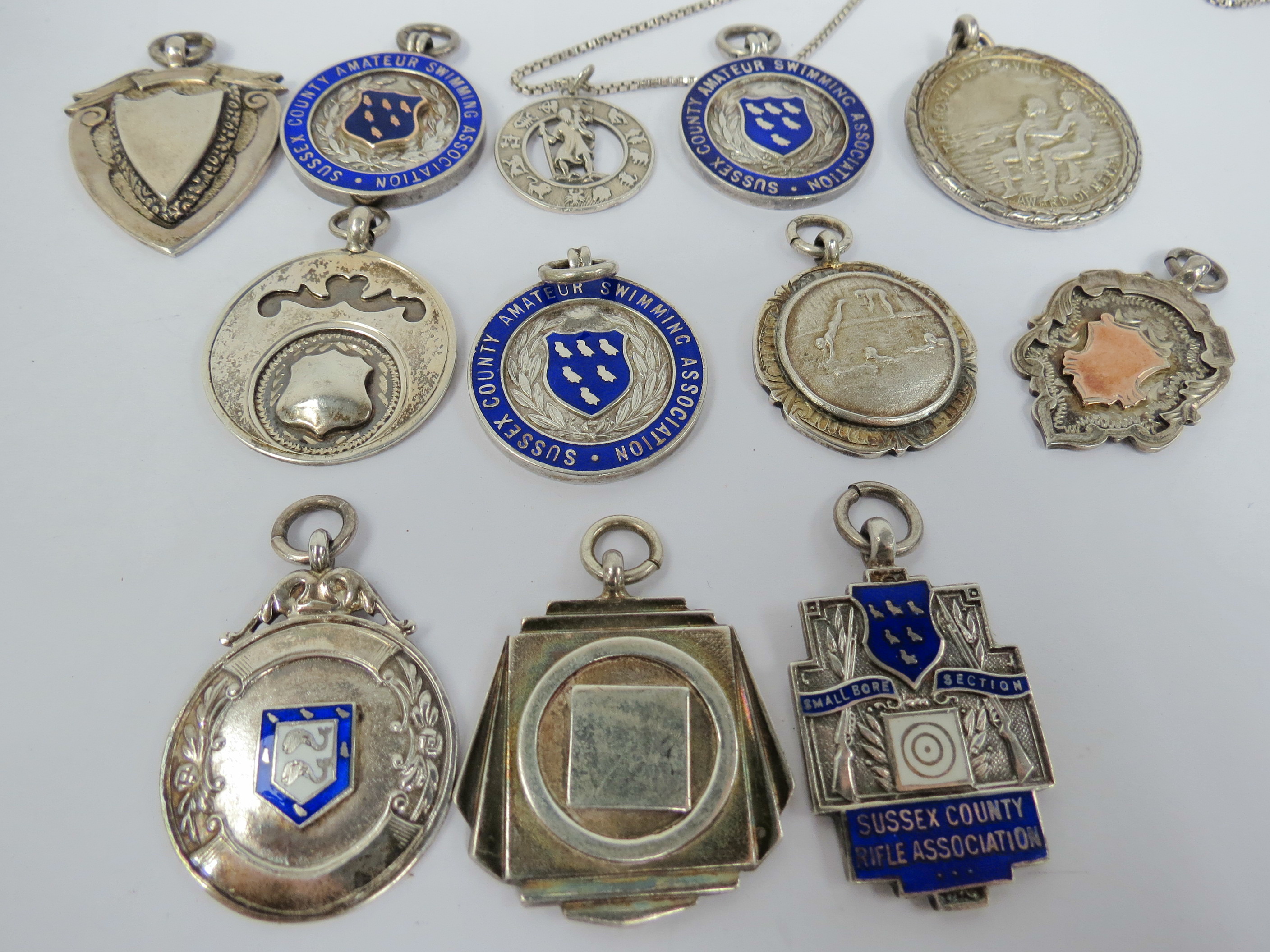 Three enamel medals from Sussex County Amateur Swimming Association awarded to the Police team in