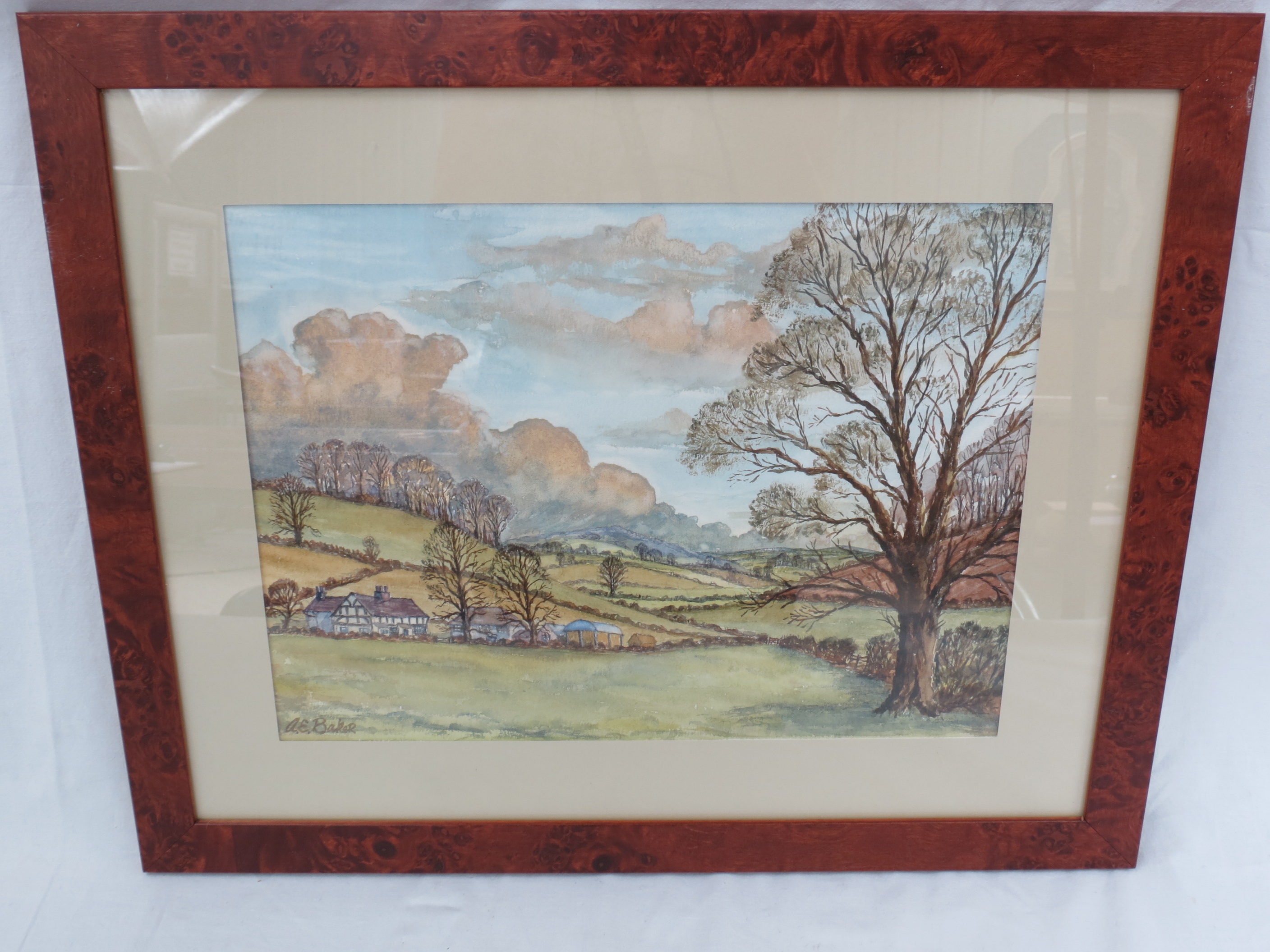 G E Baker. Farmstead in rolling countryside, watercolour, signed lower left, measuring 25x34cm.