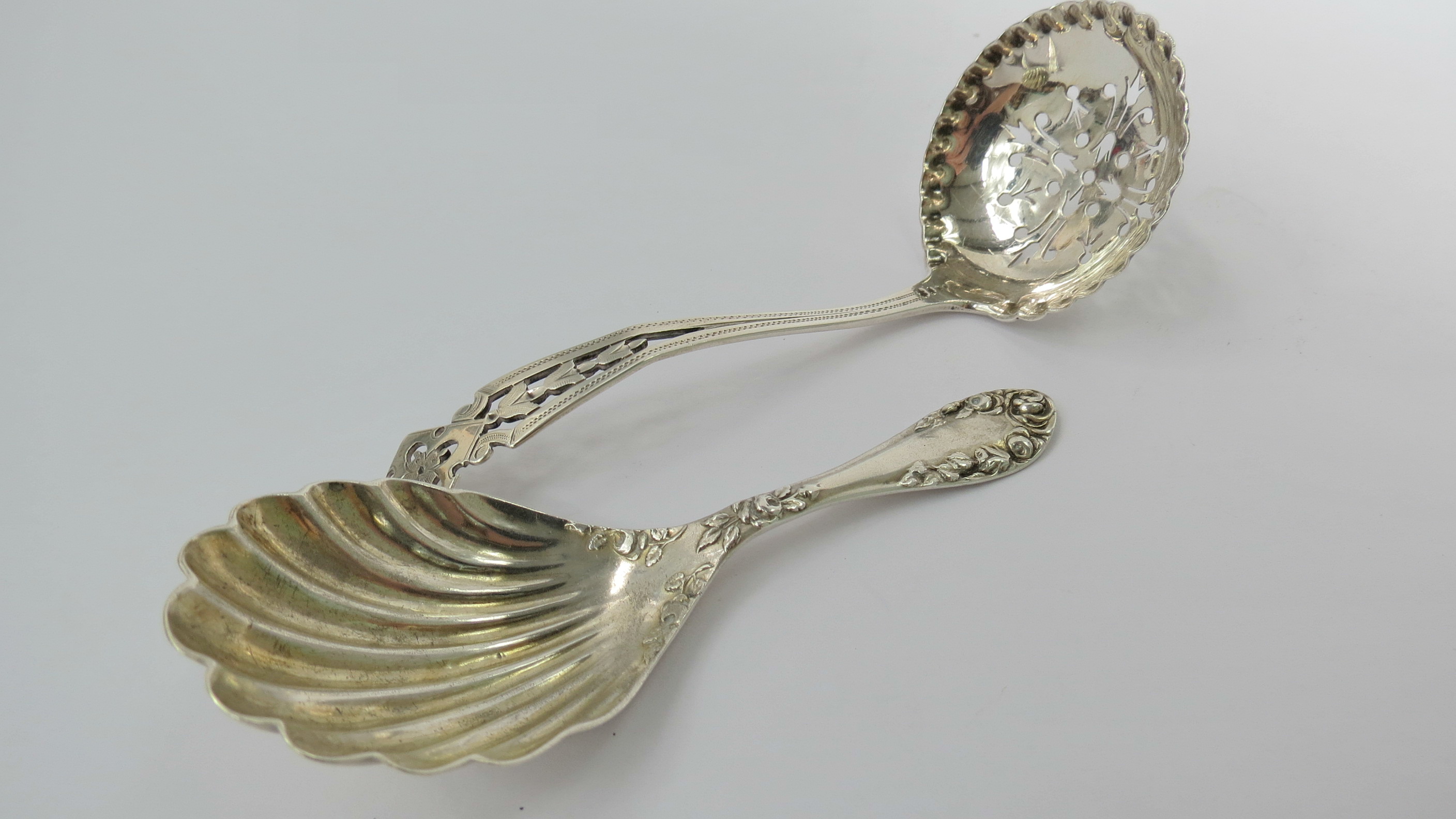 A silver sifter spoon, Brewis & Co, Sheffield 1912 with pierced bellflower decoration with a
