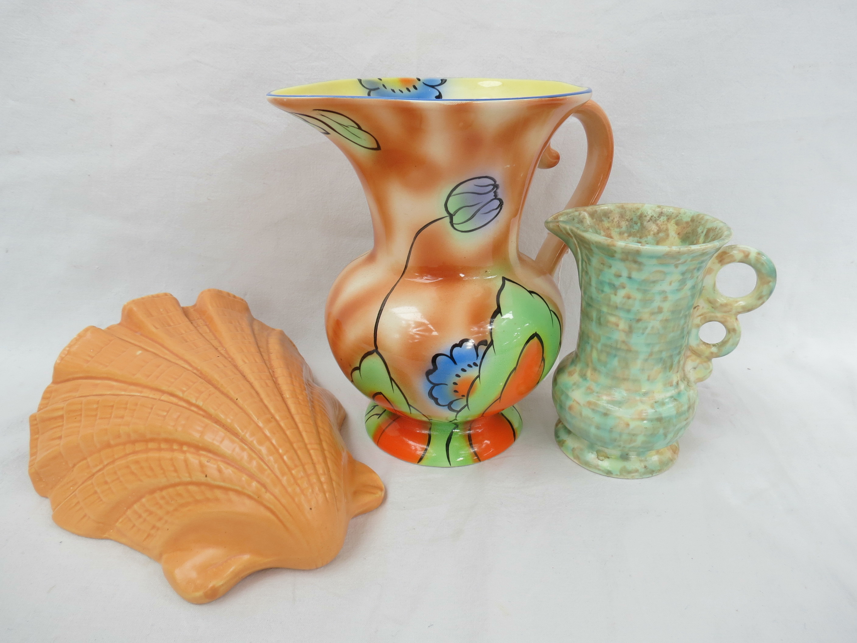 A Parrot & Co art deco jug, a Wade Heath Flaxmanware jug and a Bretby wall pocket.