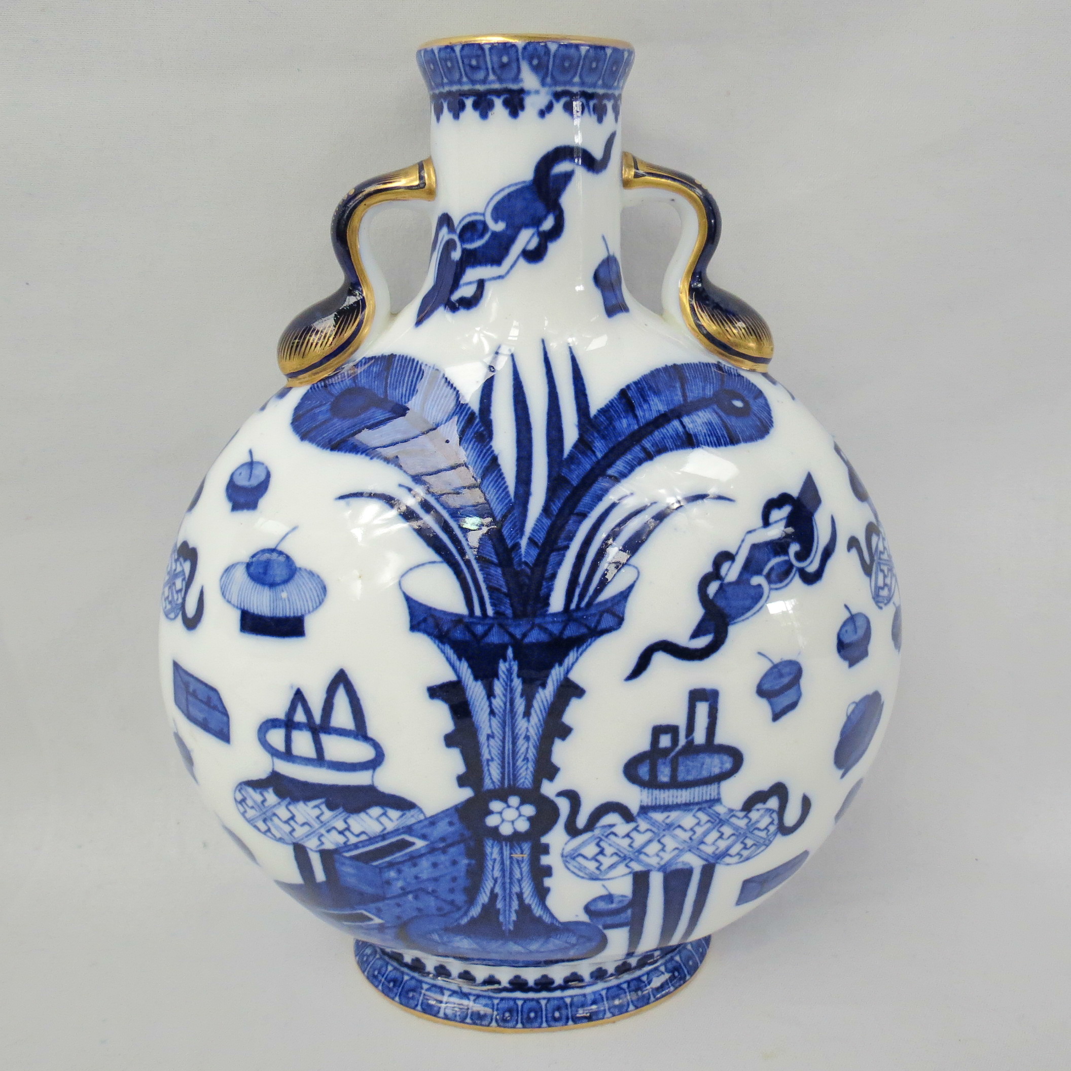 A late 19thC Moon flask, with twin handles to the neck and decorated in a blue and white oriental
