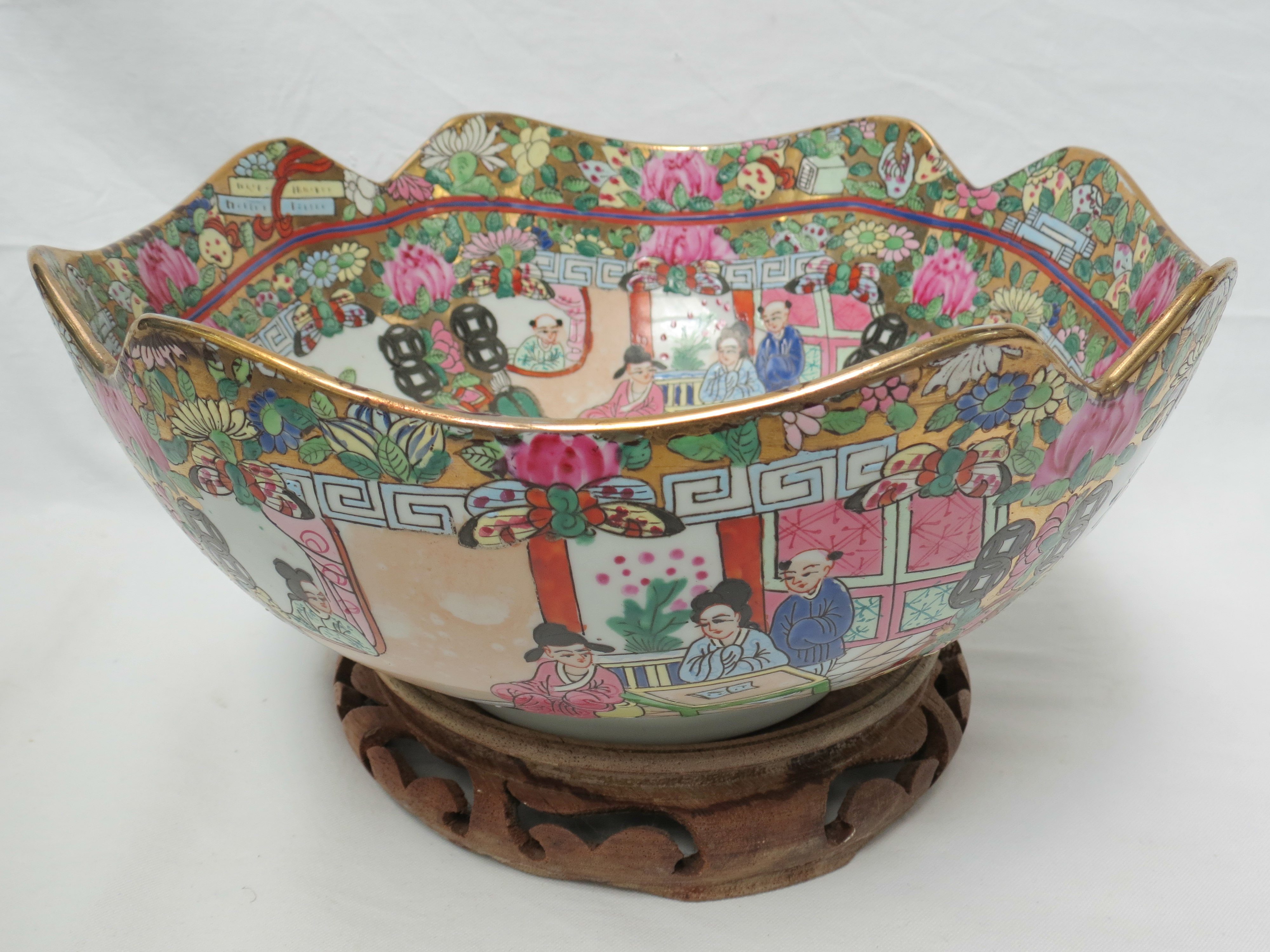 A famile rose bowl with scooped gilded rim, decoration of foliage birds and costumed figures, 24cm