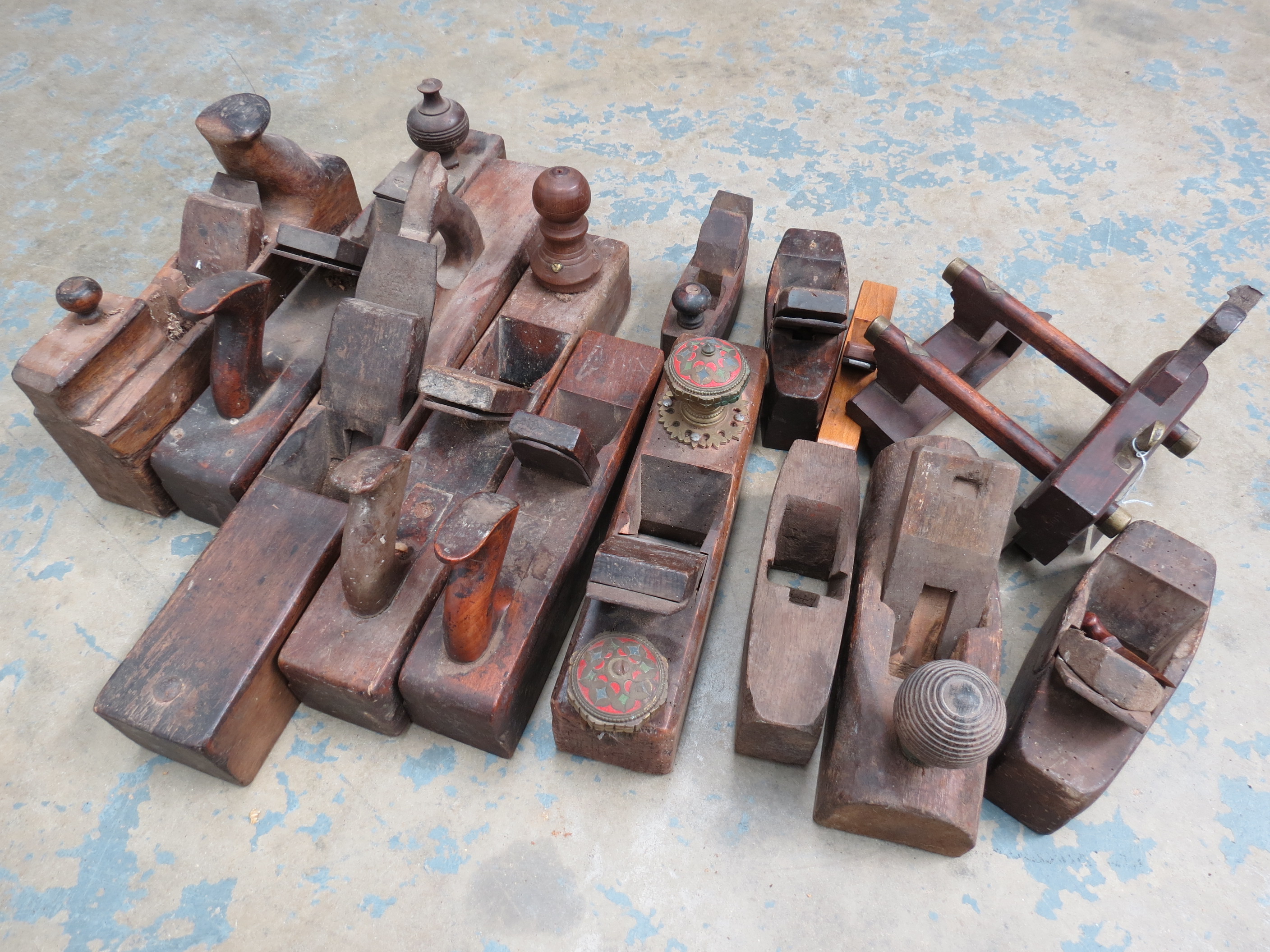 An early 20thC wooden and brass mounted plough plane together with eleven other wooden jack,