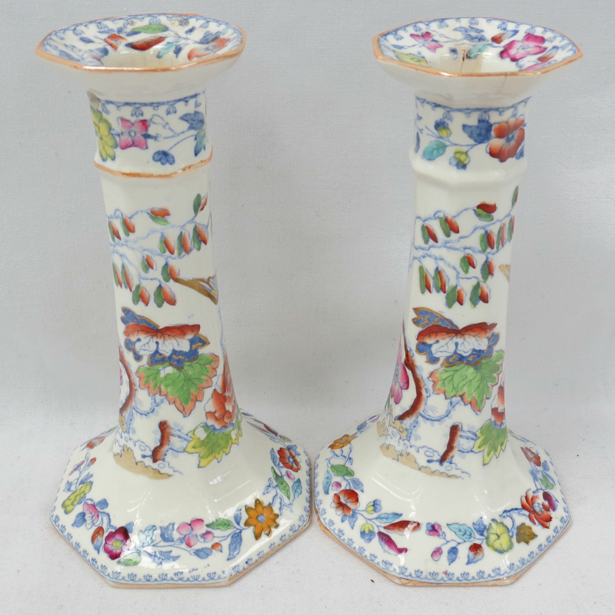 A pair of late 19thC Masons Ironstone candlesticks of tapering octagonal form, the transfer