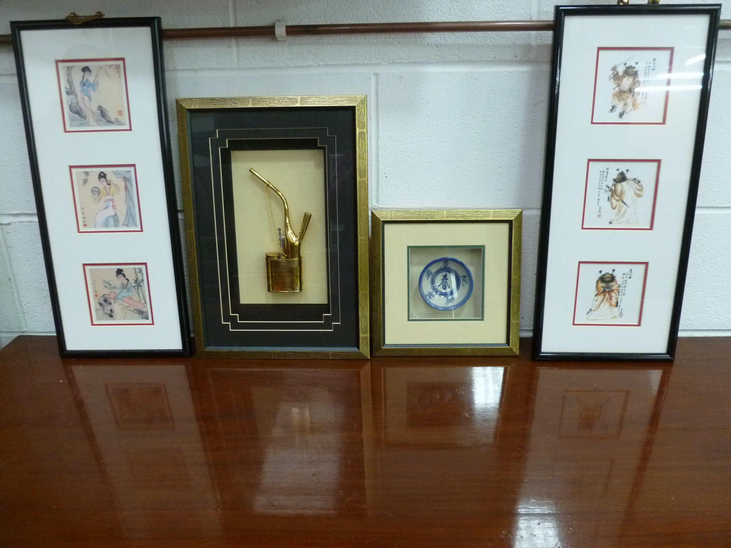 A quantity of framed Oriental pictures, measuring 53 x 23cm, pipe and tea bowl. Four items.
