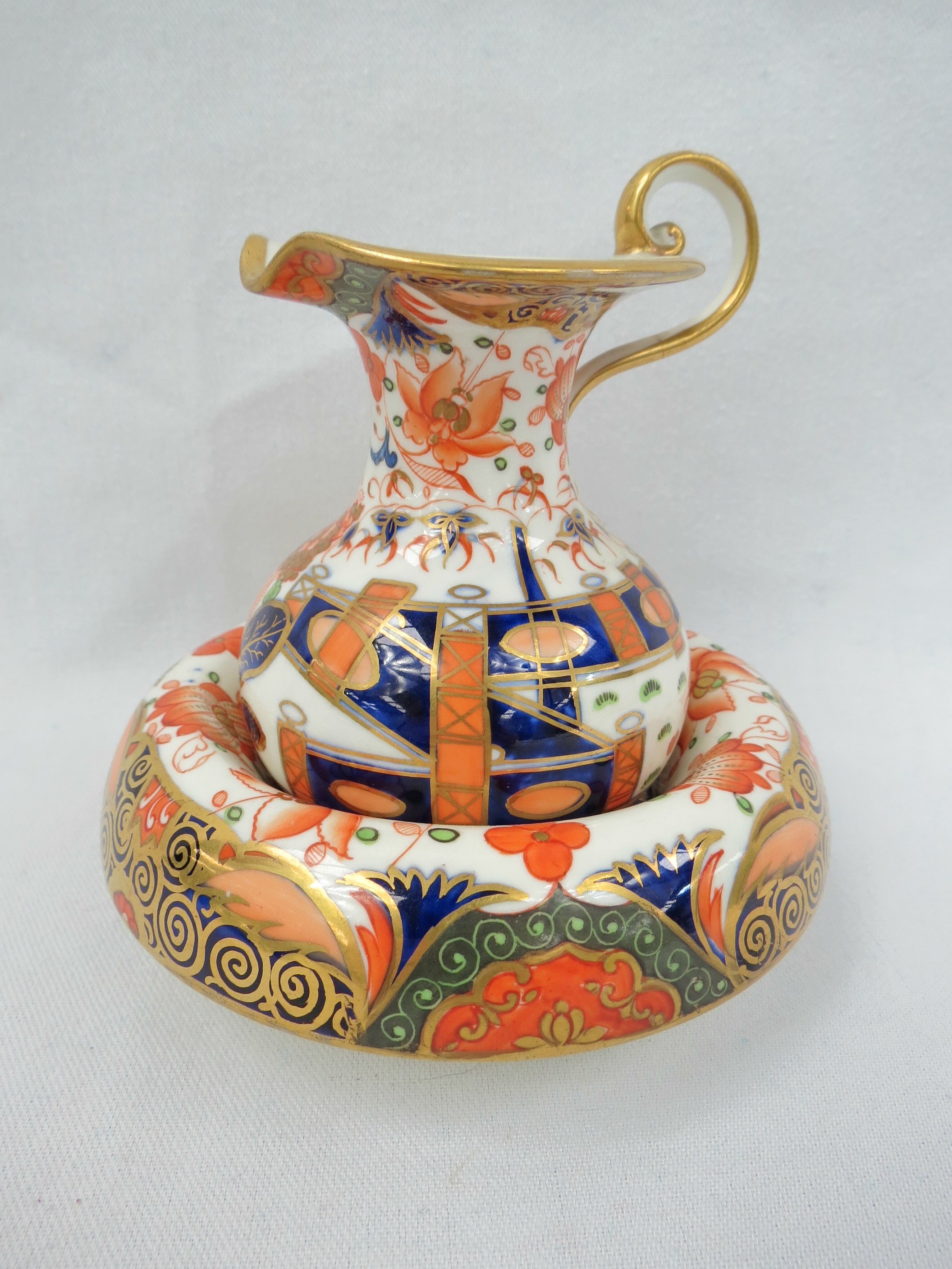 A miniature ewer and basin in Imari palette by Davenport, red mark beneath (1794-1887). Height of