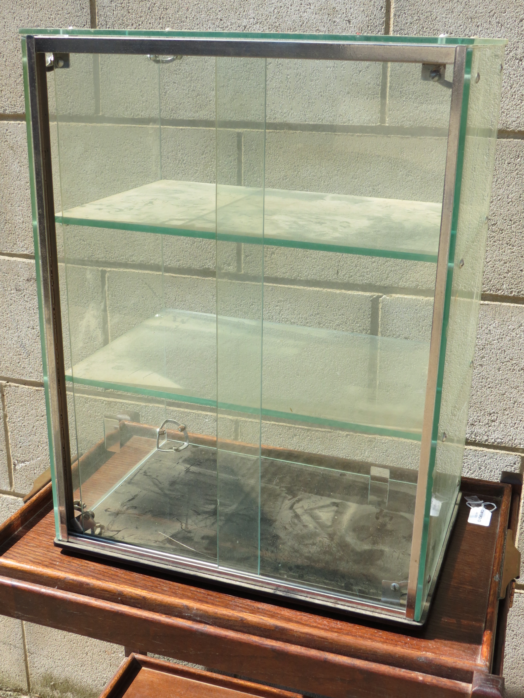 A 20thC Smiths clock and watch display case, etched with retailers name, 45cm wide.