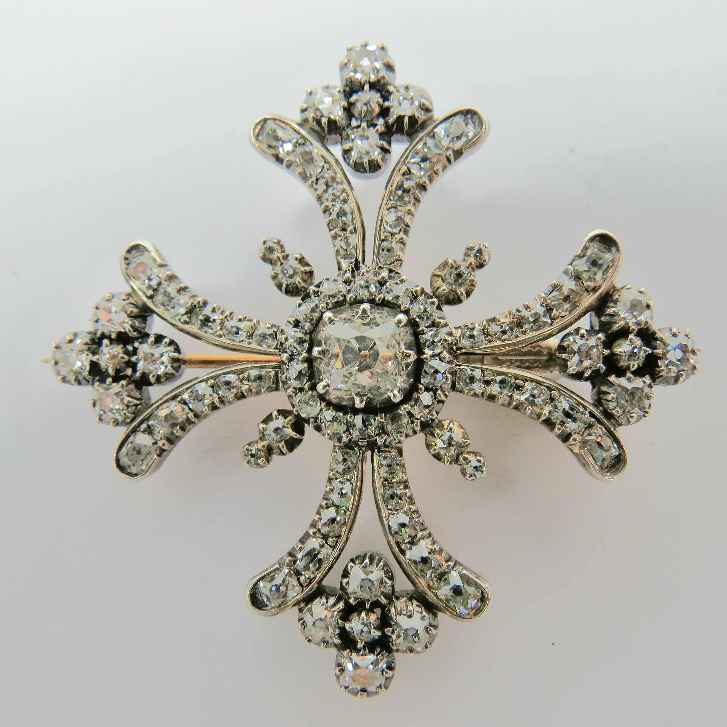 A diamond set stylised Huguenot cross with central cushion shaped hobnail diamond, weight approx 0.