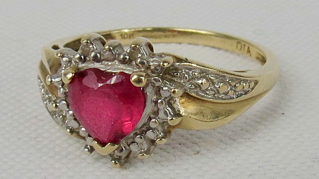 A 9ct heart shaped ruby (untested) and white stone cluster.