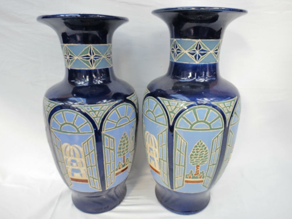 A large pair of flared lip baluster vases with window designs on blue ground, of recent manufacture,