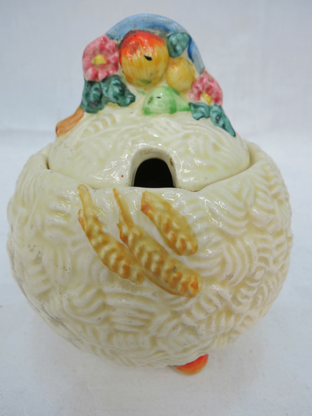 A Clarice Cliff Celtic Harvest preserve pot and cover.