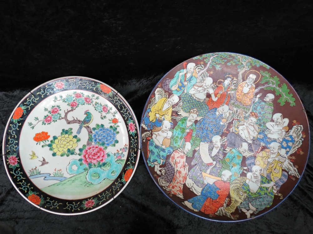 A very large Japanese charger depicting scholars and Divines conversing beneath trees, 21.5" dia.