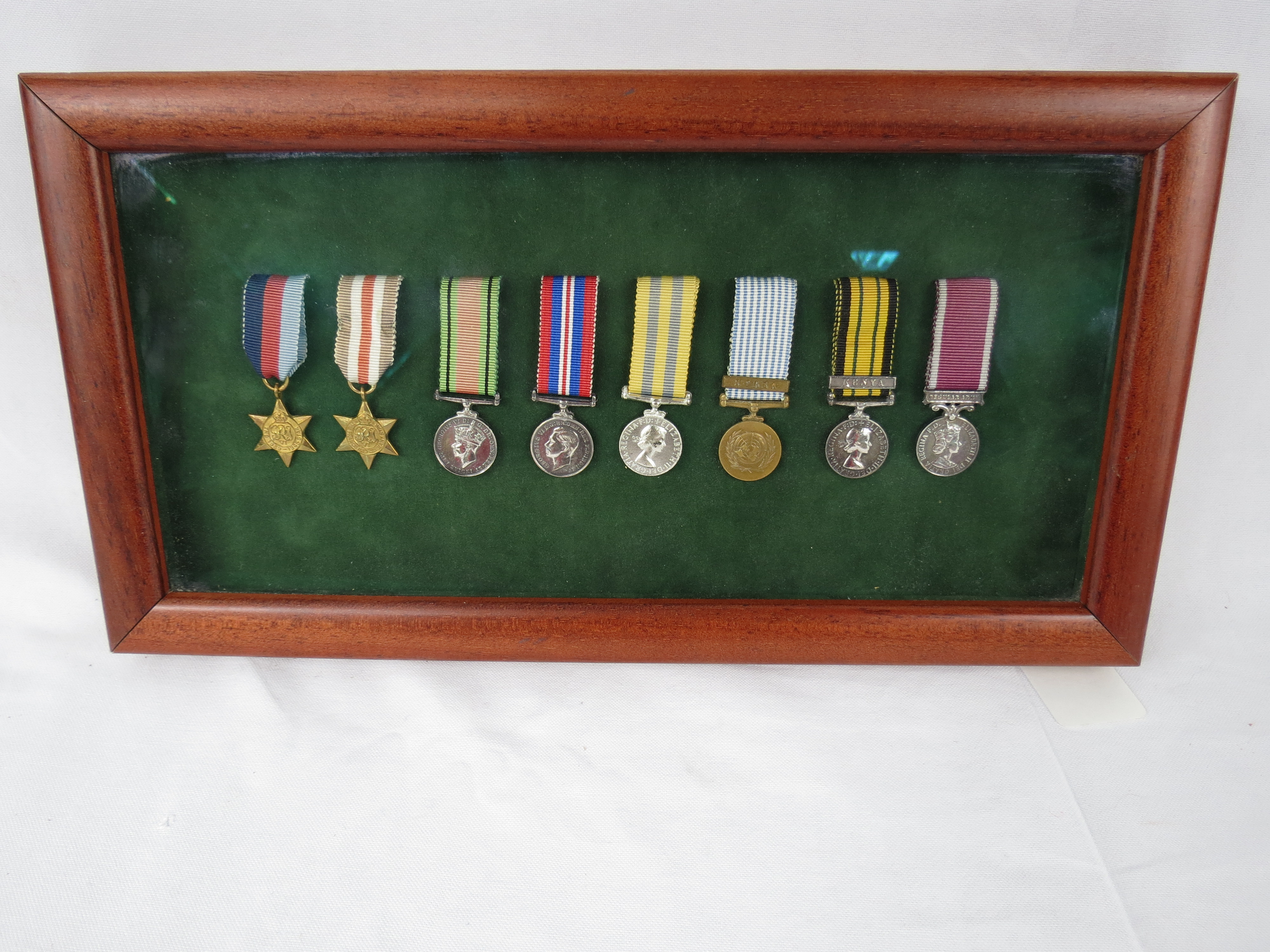 A collection of miniature medals within display case consisting of 1939-1945 Star, France and