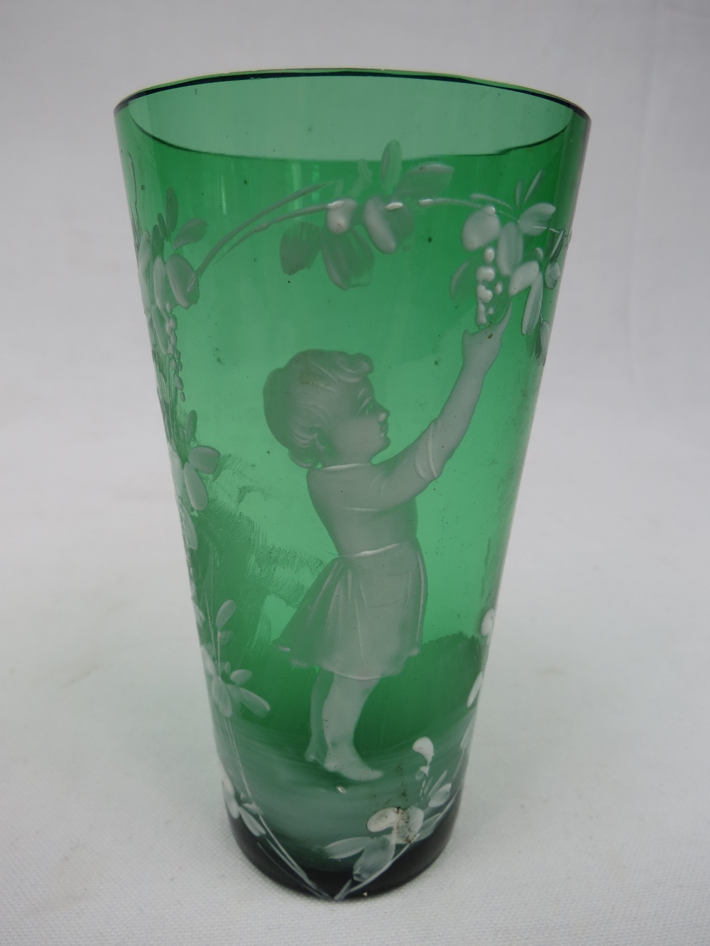 A Victorian green glass beaker vase with Mary Gregory style overlay decoration.